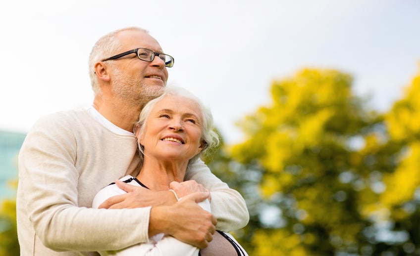 senior couple hugging in park